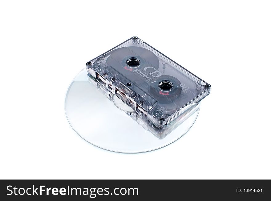 Analog audio tape cassette and digital compact disc on white background