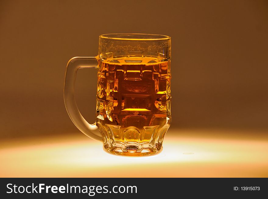 Beer mug filled with beer on one color background. Beer mug filled with beer on one color background