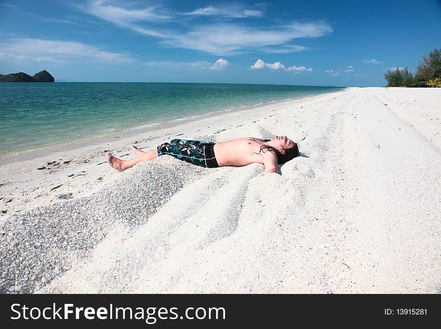 Young girl relaxing on the beach. Young girl relaxing on the beach.