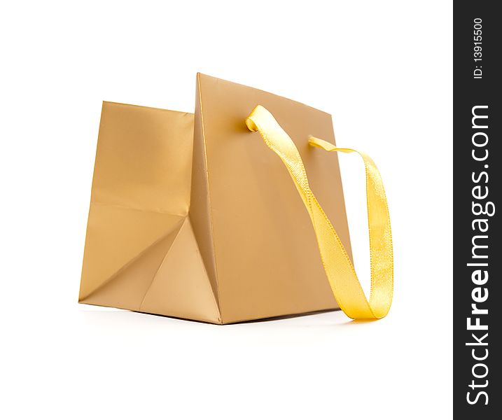 Gift package of gold colour on a white background