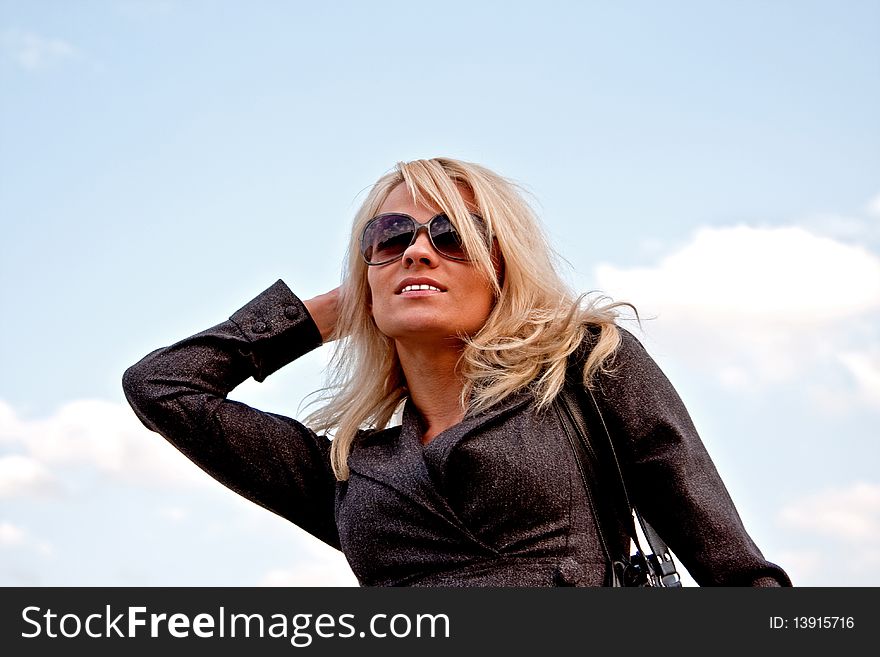 Smiling beautifull women in sunglasses with sky background