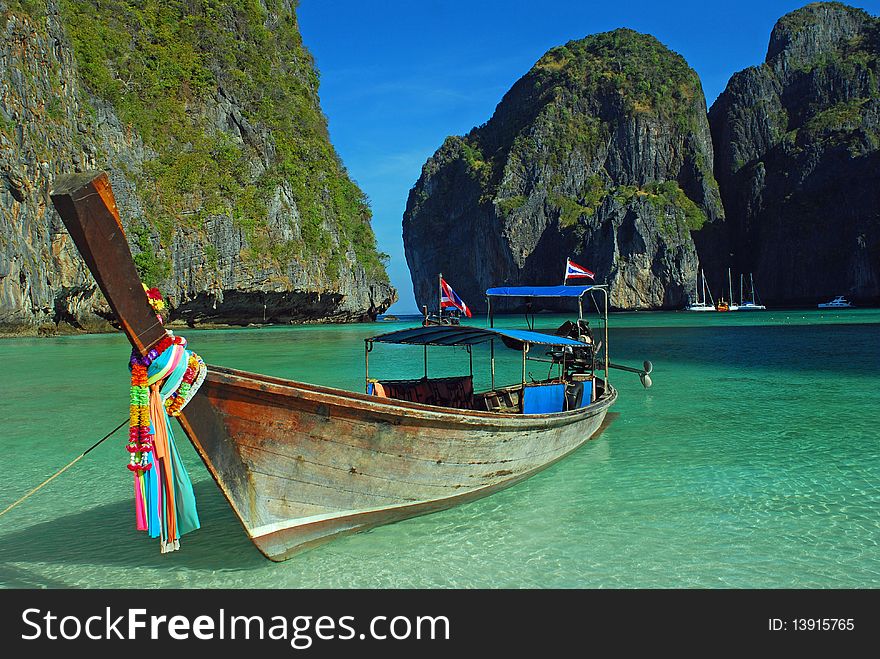 Longboat anchored at maya bay, thailand. Crystal clear waters, clear skies and perfect scenery. Longboat anchored at maya bay, thailand. Crystal clear waters, clear skies and perfect scenery.