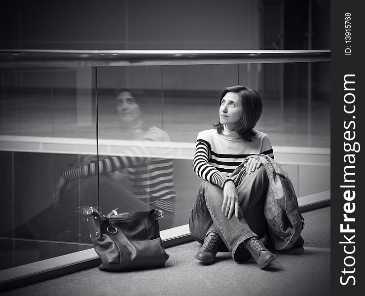 Girl resting in the hall of exhibition center. picture with vignetting. Girl resting in the hall of exhibition center. picture with vignetting