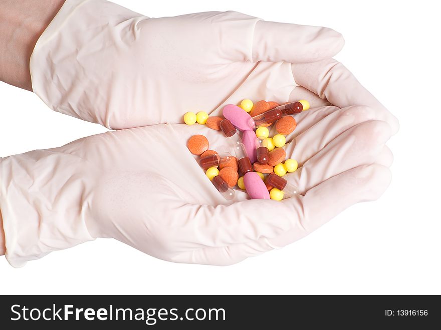 Female hands in rubber gloves holding medicines