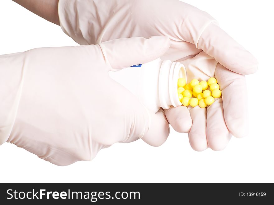 Female hands in rubber gloves holding medicines