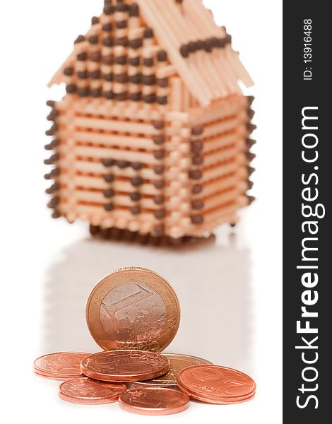 Euro coins on house with white isolated background