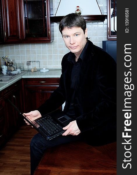 Handsome stylish man at home with a laptop. Handsome stylish man at home with a laptop