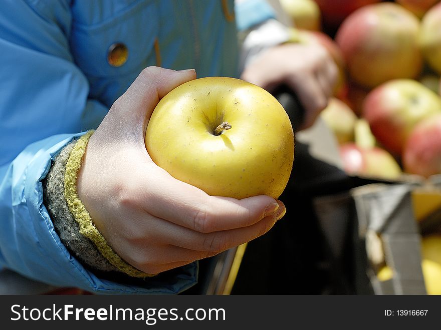 Green Apple in child's arm