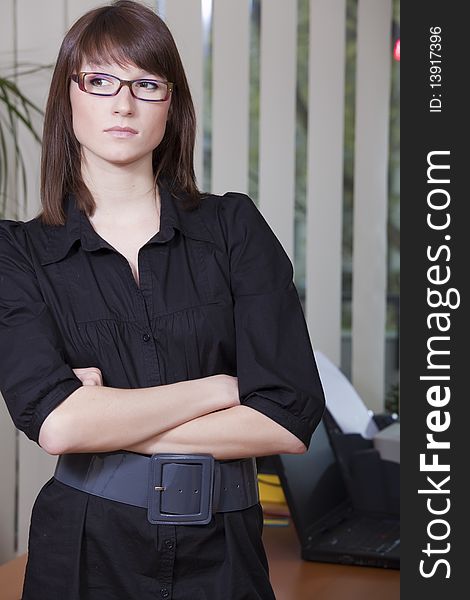 Thinking business woman standing in the office. Thinking business woman standing in the office