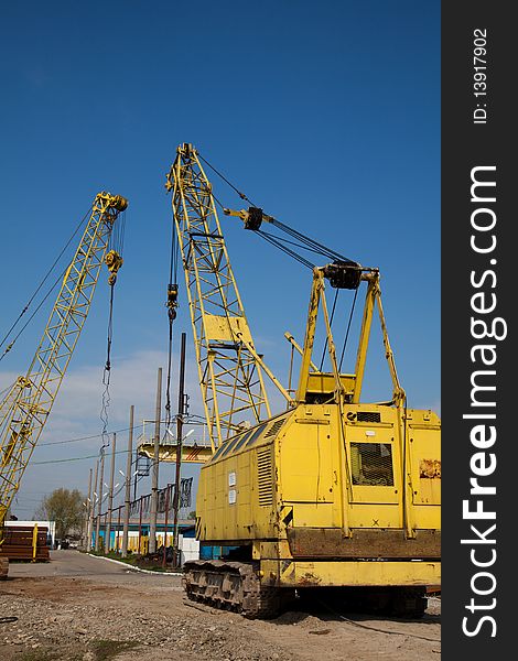 Yellow cranes at an industrial site in Romania.