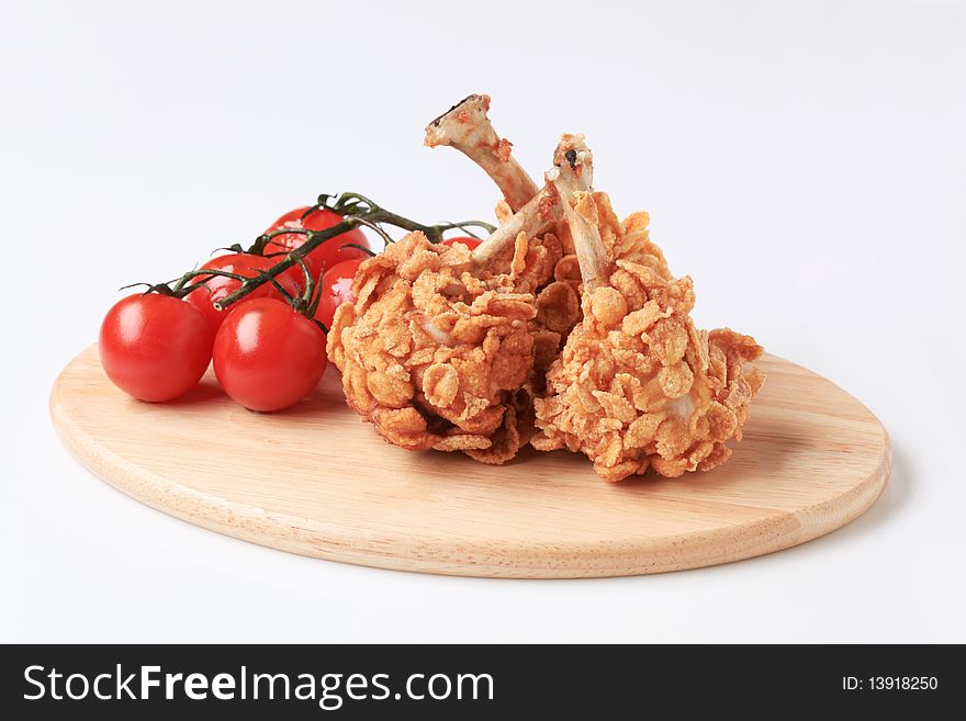 Chicken drumsticks coated with corn flakes