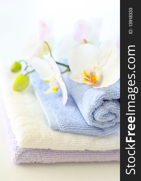 Tender orchids and towels thumbs on the table. Tender orchids and towels thumbs on the table