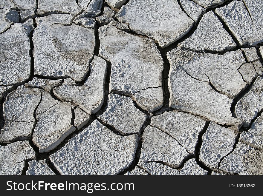 Salinized eroded soil - dry cracked earth. Salinized eroded soil - dry cracked earth