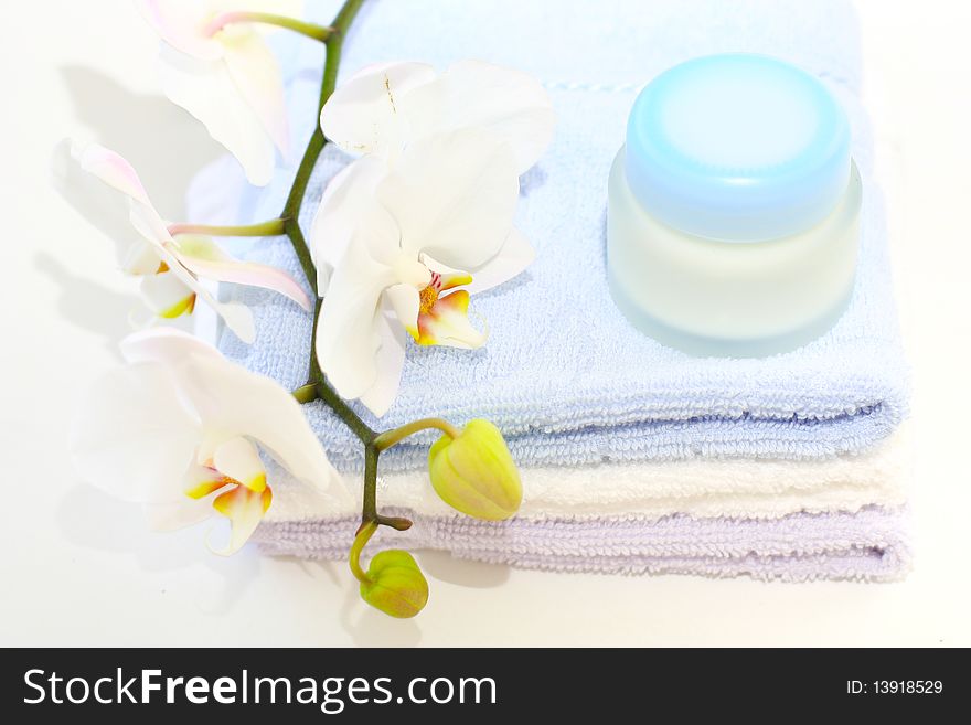 Tender orchids, creme and towels on the table