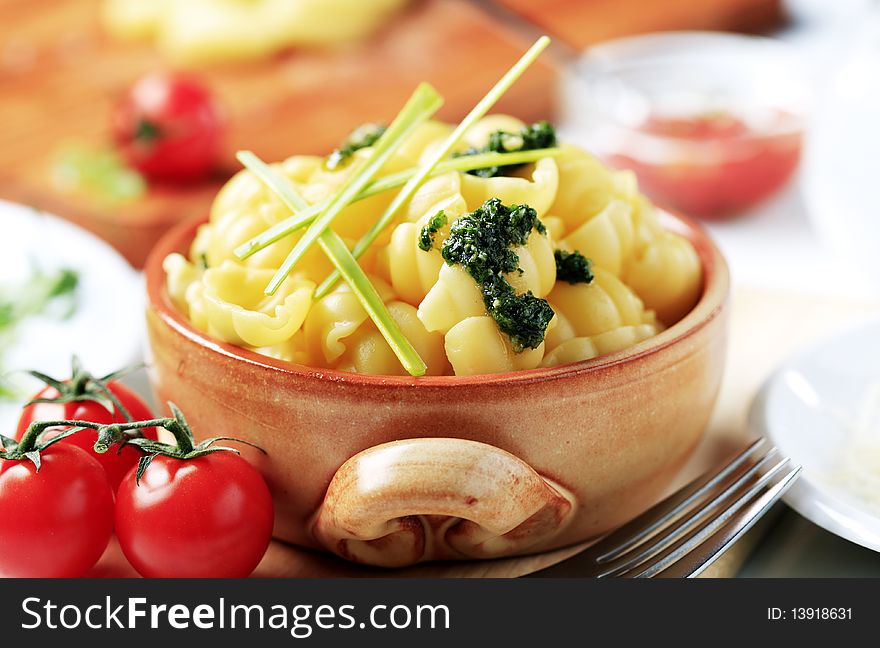 Boiled pasta with pesto in an earthenware dish