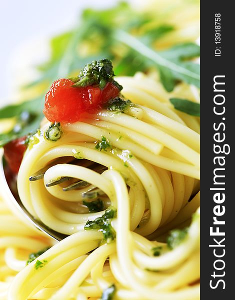 Macro shot of spaghetti twirled around a fork