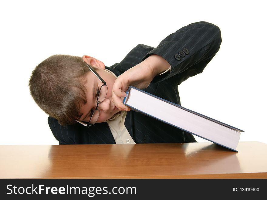 Boy with points looks under book isolated in white