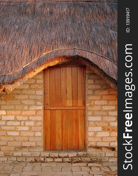Wood door and thatched roof of a home in Tanzania. Wood door and thatched roof of a home in Tanzania