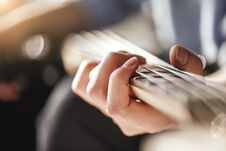 Guitar Lessons. Close-up Photo Of Male Playing Guitar Royalty Free Stock Photography