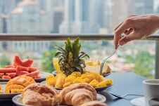 Breakfast Table With Coffee Fruit And Bread Croisant On A Balcony Against The Backdrop Of The Big City Royalty Free Stock Photography