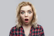 Closeup Portrait Of Shocked Beautiful Blonde Young Woman In Casual Red Checkered Shirt Standing With Big Eyes And Looking At Royalty Free Stock Photography