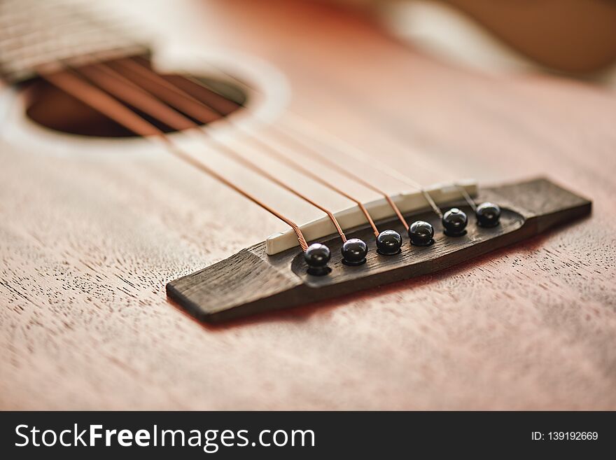 Sound adjusting. Close up detailed photo of guitar strings and sound hole.
