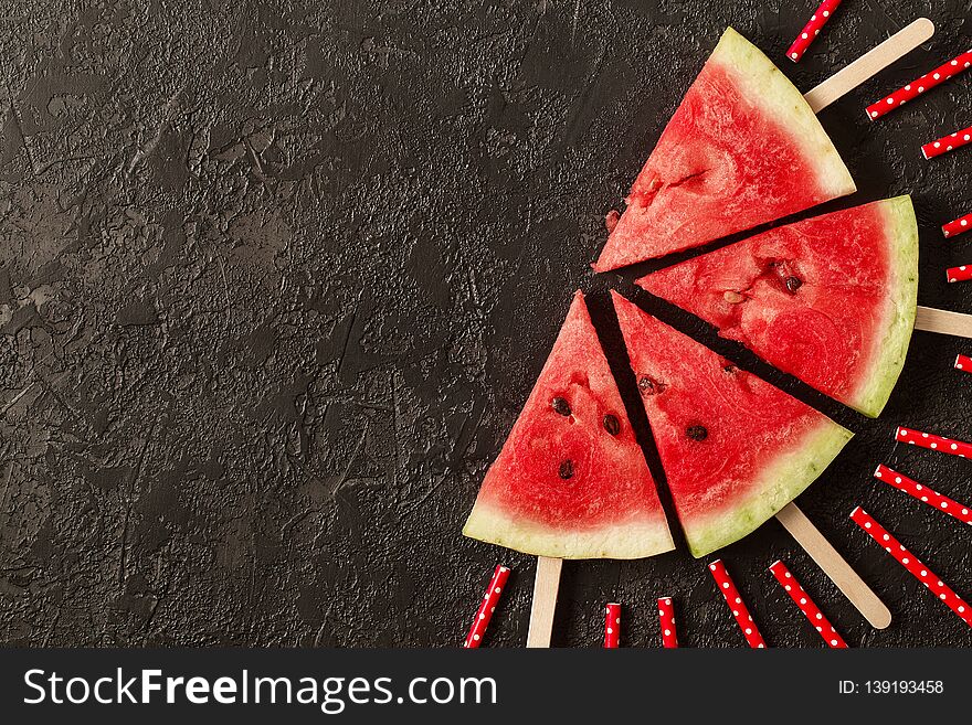 Sliced juicy watermelon on textured concrete background. Top view with copy space