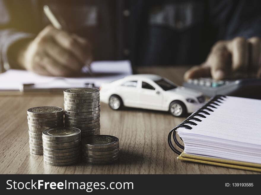 Car insurance and car service. Businessman and toy car for accounting and financial concept
