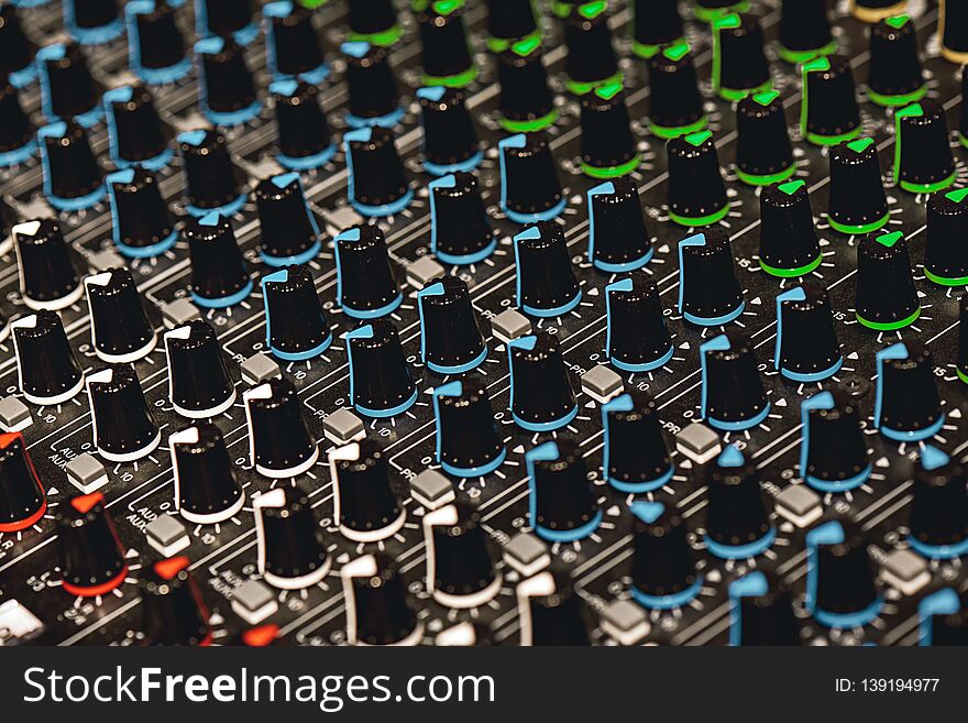Professional Sound Mixer. Close-up view of colorful control buttons for sound adjusting in a recording studio