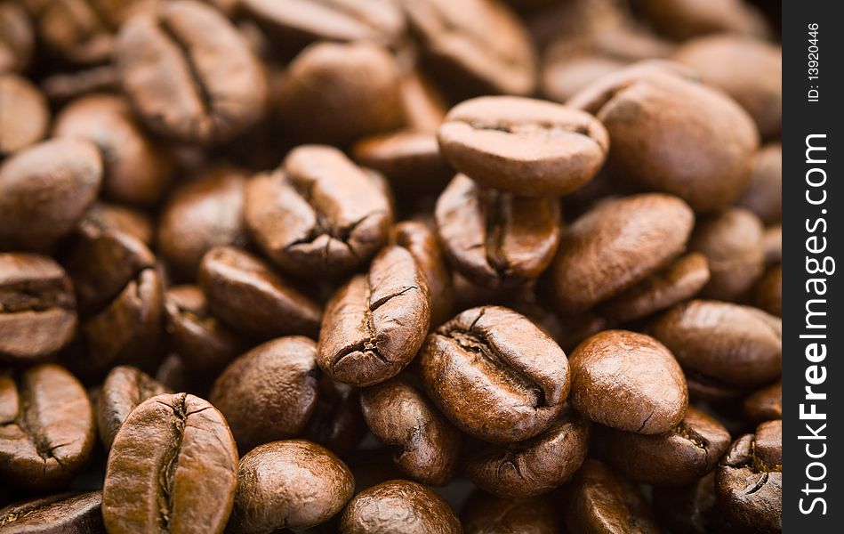 Rich brown coffee beans in pile. Rich brown coffee beans in pile