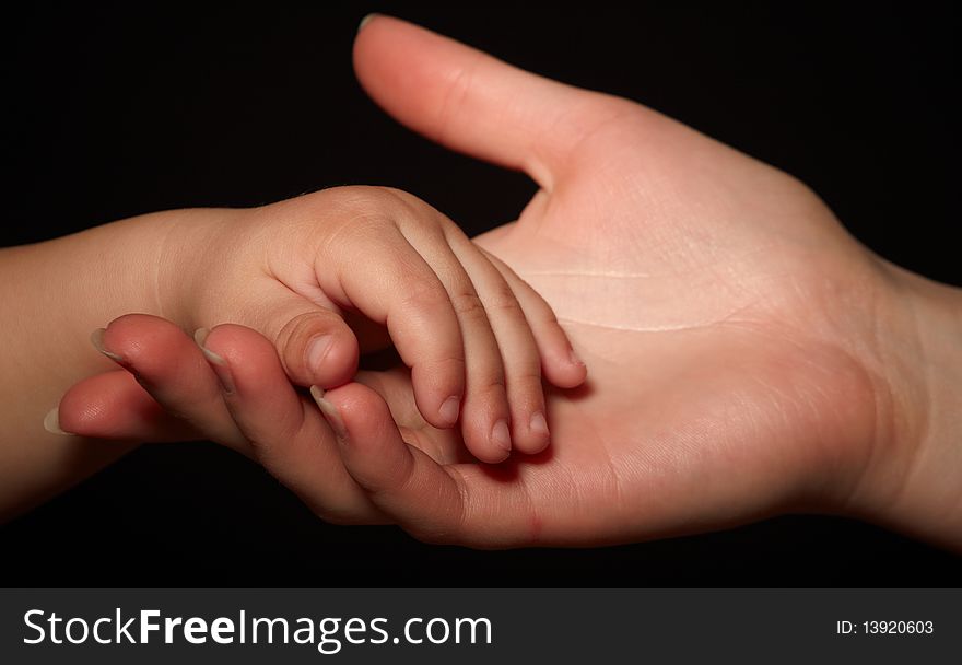 Hands of son and mother. loving touch