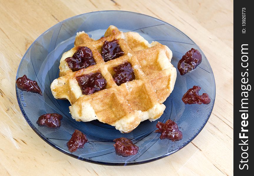 Homemade waffle with cherry jam