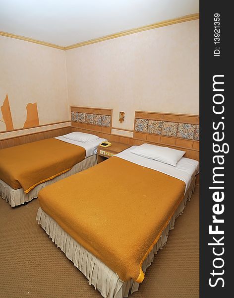 Twin beds neatly done up in a high class hotel room. Suitable for concepts such as travel, tourism, vacation and holiday. Twin beds neatly done up in a high class hotel room. Suitable for concepts such as travel, tourism, vacation and holiday.