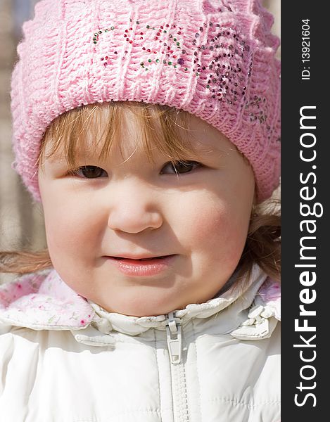 Portrait of the little girl in a cap