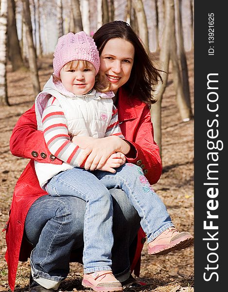 Mum with a daughter walking in park