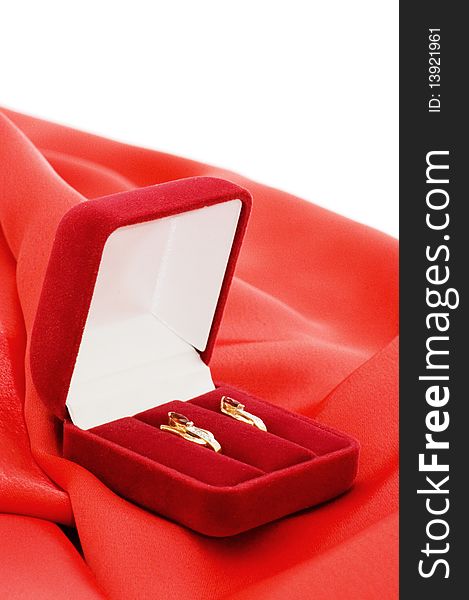 Gold earrings in a red box