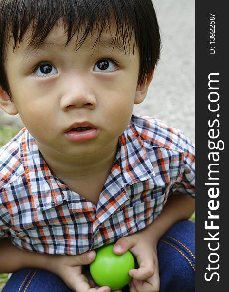 Portrait of a young Asian boy playing at a park