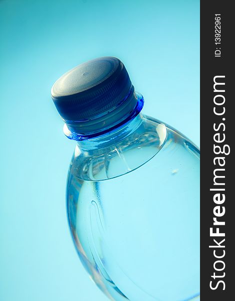 A plastic bottle filled with still water. Image isolated on light blue studio background.
Focus on bottle cap. A plastic bottle filled with still water. Image isolated on light blue studio background.
Focus on bottle cap