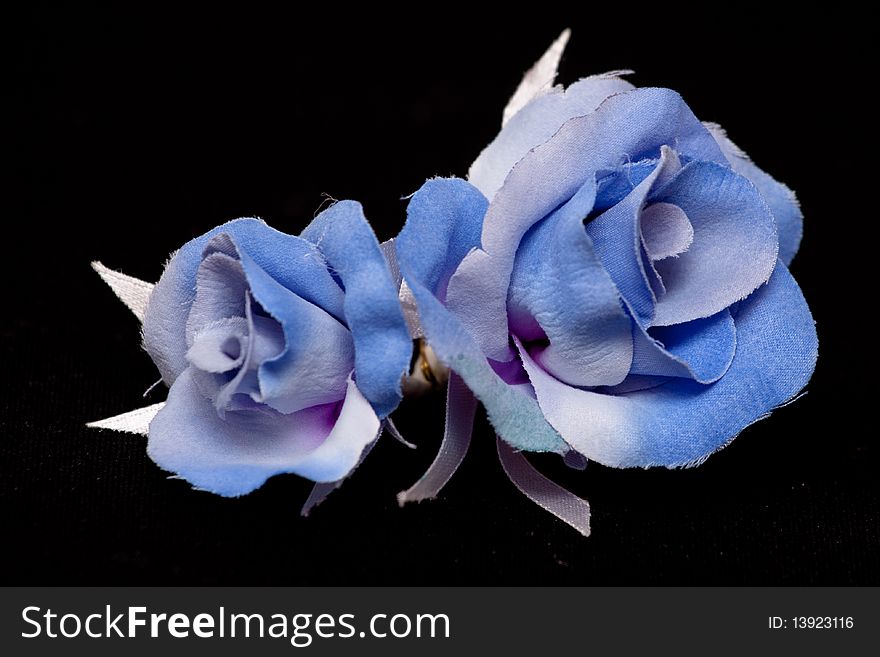 Two artificial blue handmade roses on black. Two artificial blue handmade roses on black