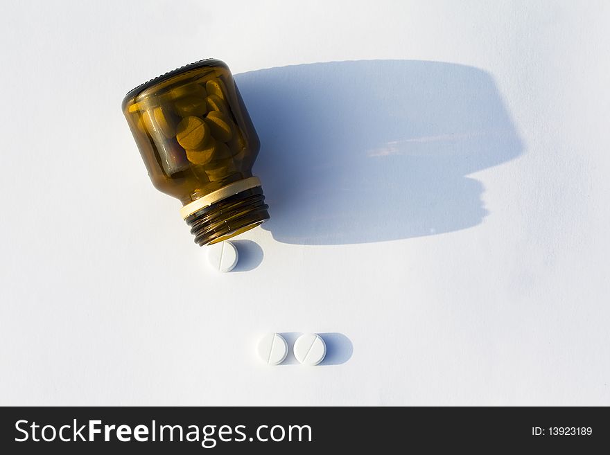 Transparent glass jar with white tablets of an antibiotic. Transparent glass jar with white tablets of an antibiotic