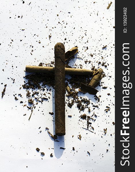 Cross from cigars with the tobacco scattered around. Cross from cigars with the tobacco scattered around