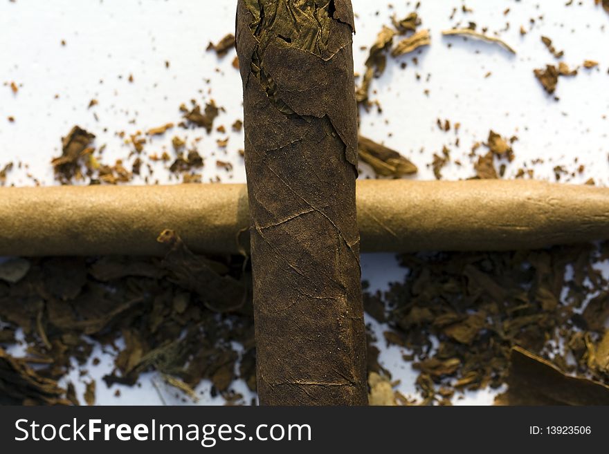 Cross from cigars with the tobacco scattered around. Cross from cigars with the tobacco scattered around