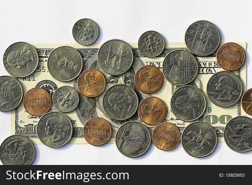 Hundred American dollars covered with various American coins. Hundred American dollars covered with various American coins