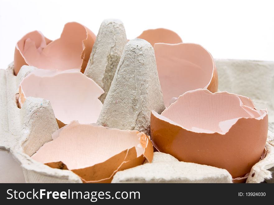 A collection of broken egg shells in cardboard egg box concept.