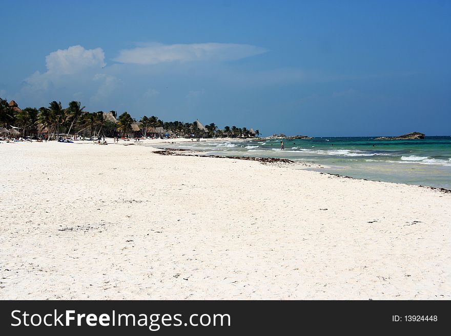 Caribbean landscape in Tulum, with sea, palms and a resort made of bungalows. Caribbean landscape in Tulum, with sea, palms and a resort made of bungalows