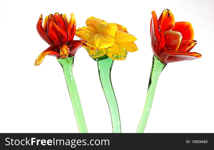 Flowers of colored glass (souvenir) closeup isolated on white.