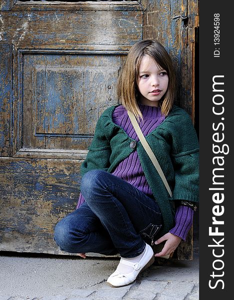 One child portrait with old door in background. One child portrait with old door in background