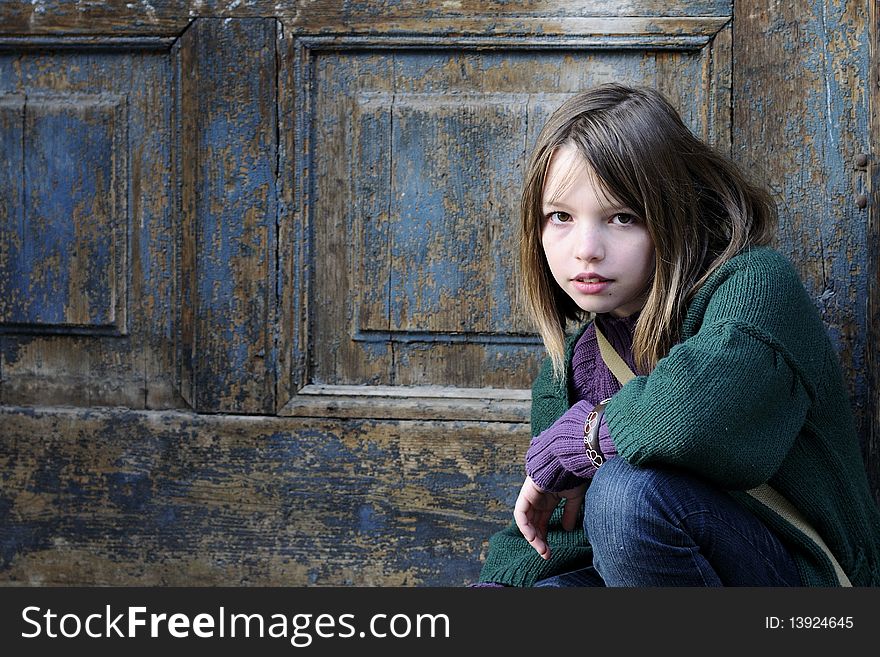 One child portrait with old door in background. One child portrait with old door in background