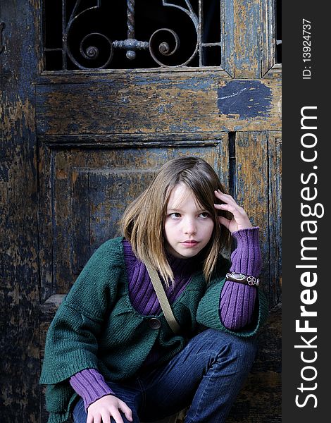 One child portrait with old door in background. One child portrait with old door in background