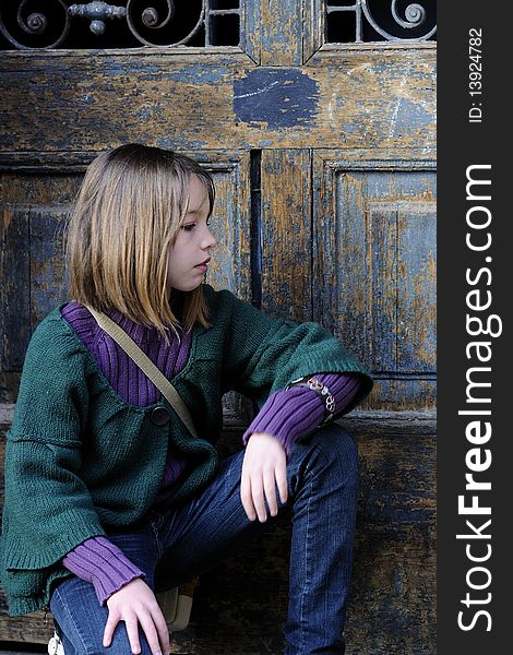 One child portrait with old door in background. One child portrait with old door in background